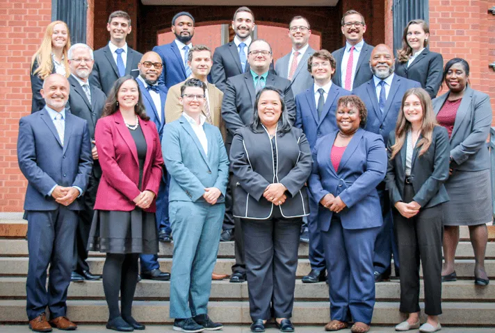 Staff of the Clerk’s Office for the U.S. Court of Appeals for the Federal Circuit stand on the courthouse steps.